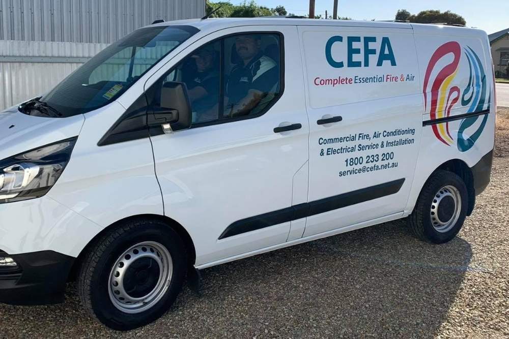 White Complete Essential Fire and Air service van parked outdoors